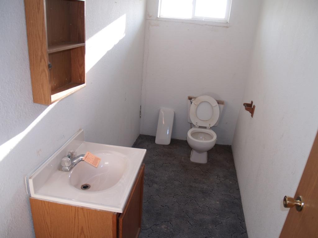 1921 Fordyce Road Sunnyside, WA 98944 - Photo 8 of 9 a bathroom with a toilet sink and mirror