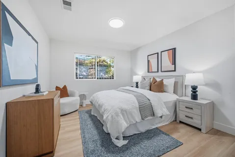 a bedroom with a bed and a window