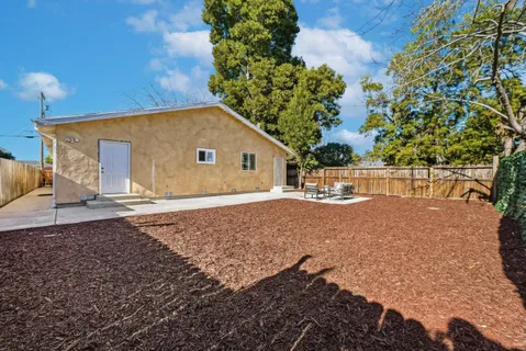 a view of backyard with seating area and green space