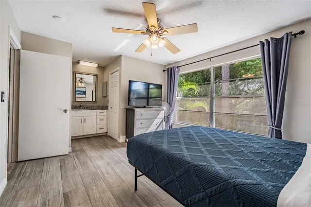 a bedroom with a large bed and a flat tv screen