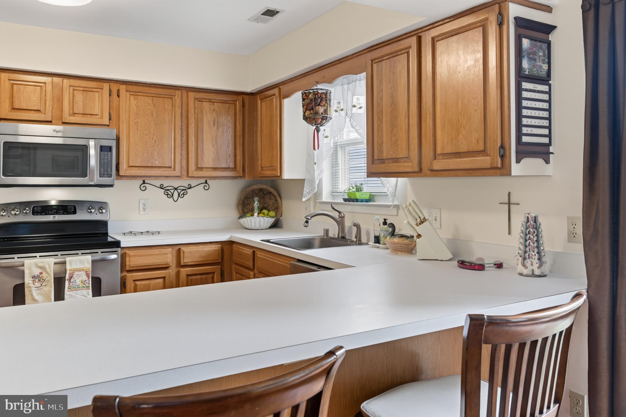 936 Bay Ridge Avenue, Unit 201 Annapolis, MD 21403 - Photo 25 of 40 a kitchen with a sink a microwave a stove and cabinets