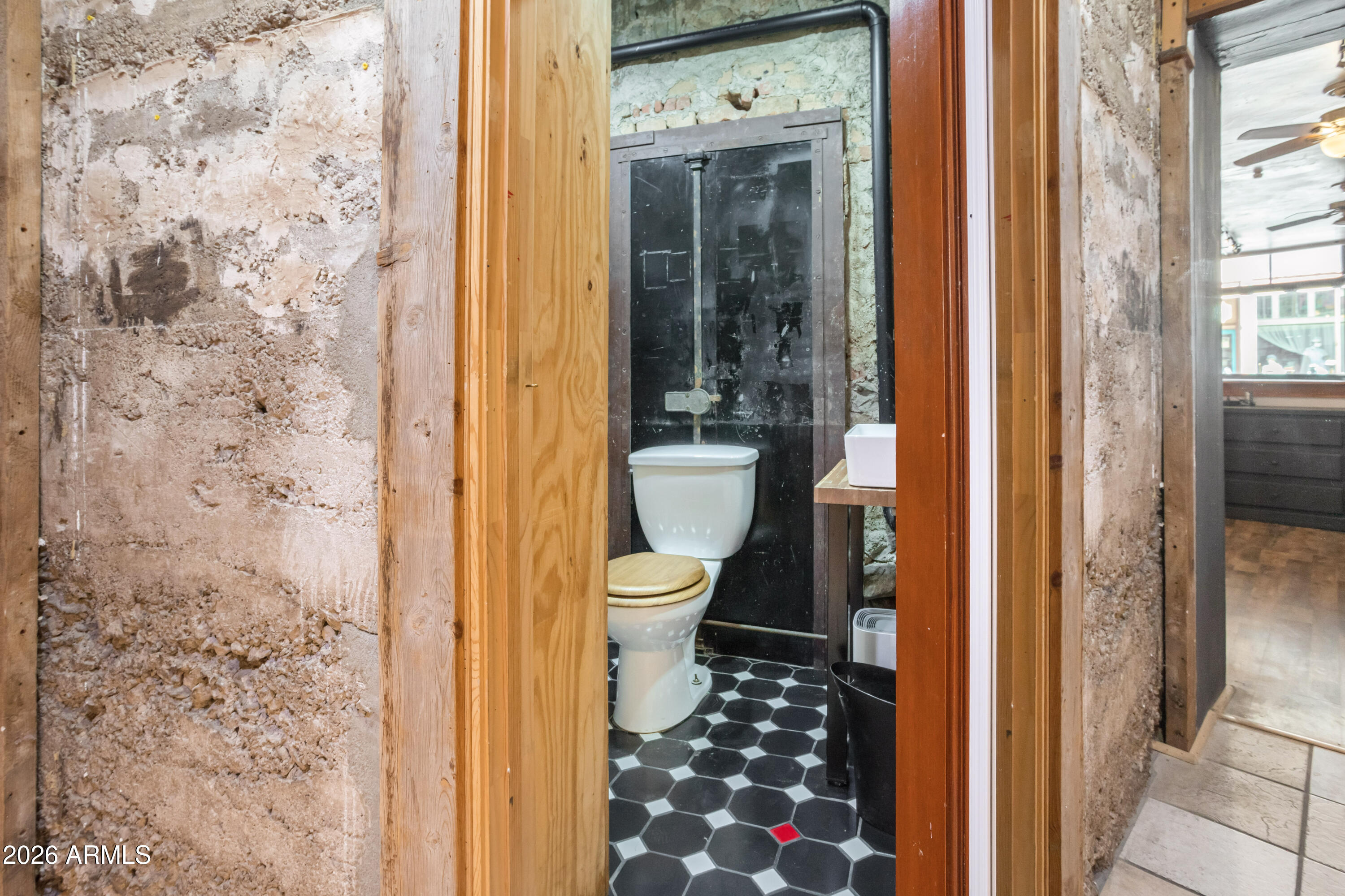 40 Main Street Bisbee, AZ 85603 - Photo 14 of 37 a bathroom with a toilet and a shower