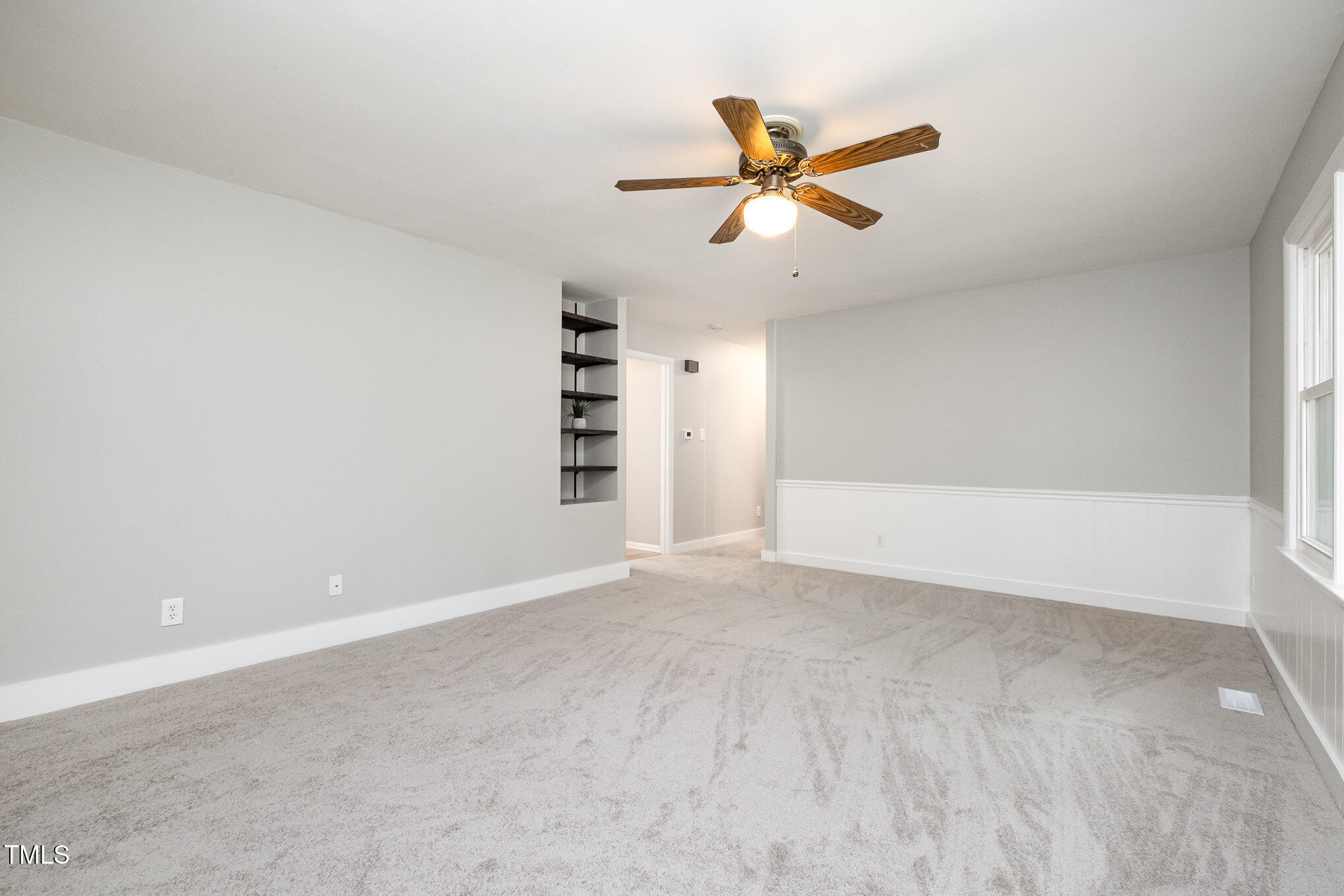 606 Chalice Street Durham, NC 27705 - Photo 12 of 41 a view of an empty room with a ceiling fan and window