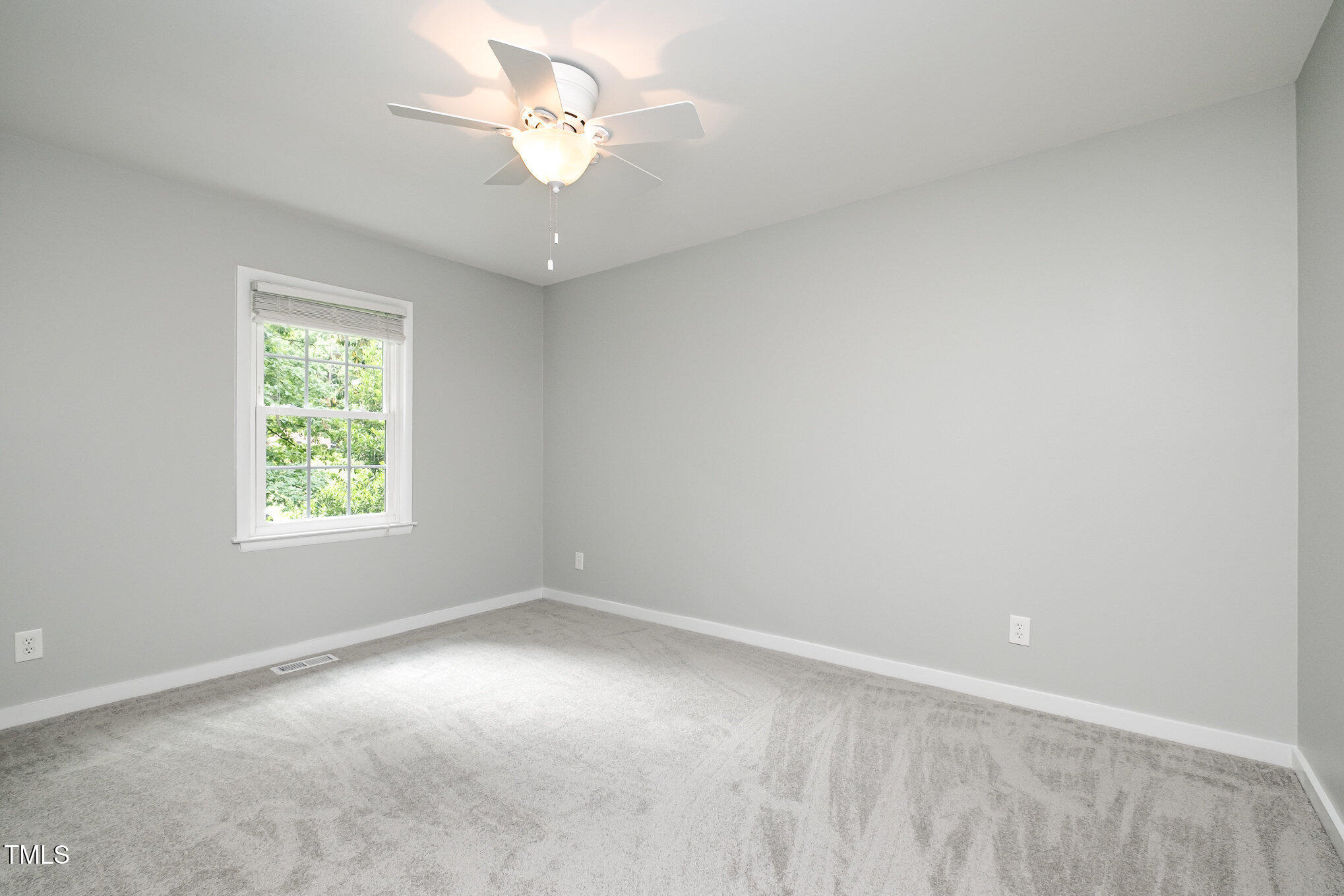 606 Chalice Street Durham, NC 27705 - Photo 17 of 41 an empty room with a window and a fan