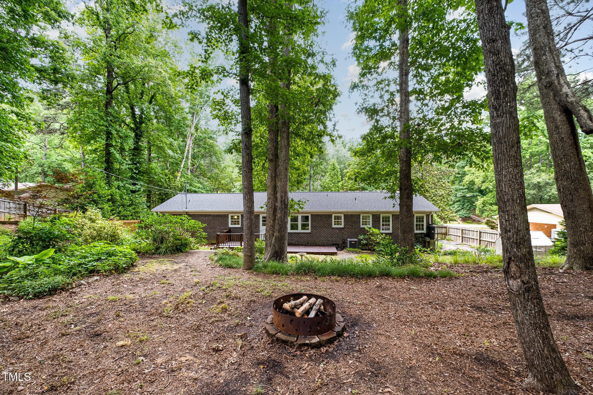 606 Chalice Street Durham, NC 27705 - Photo 23 of 41 a view of a backyard with garden and trees