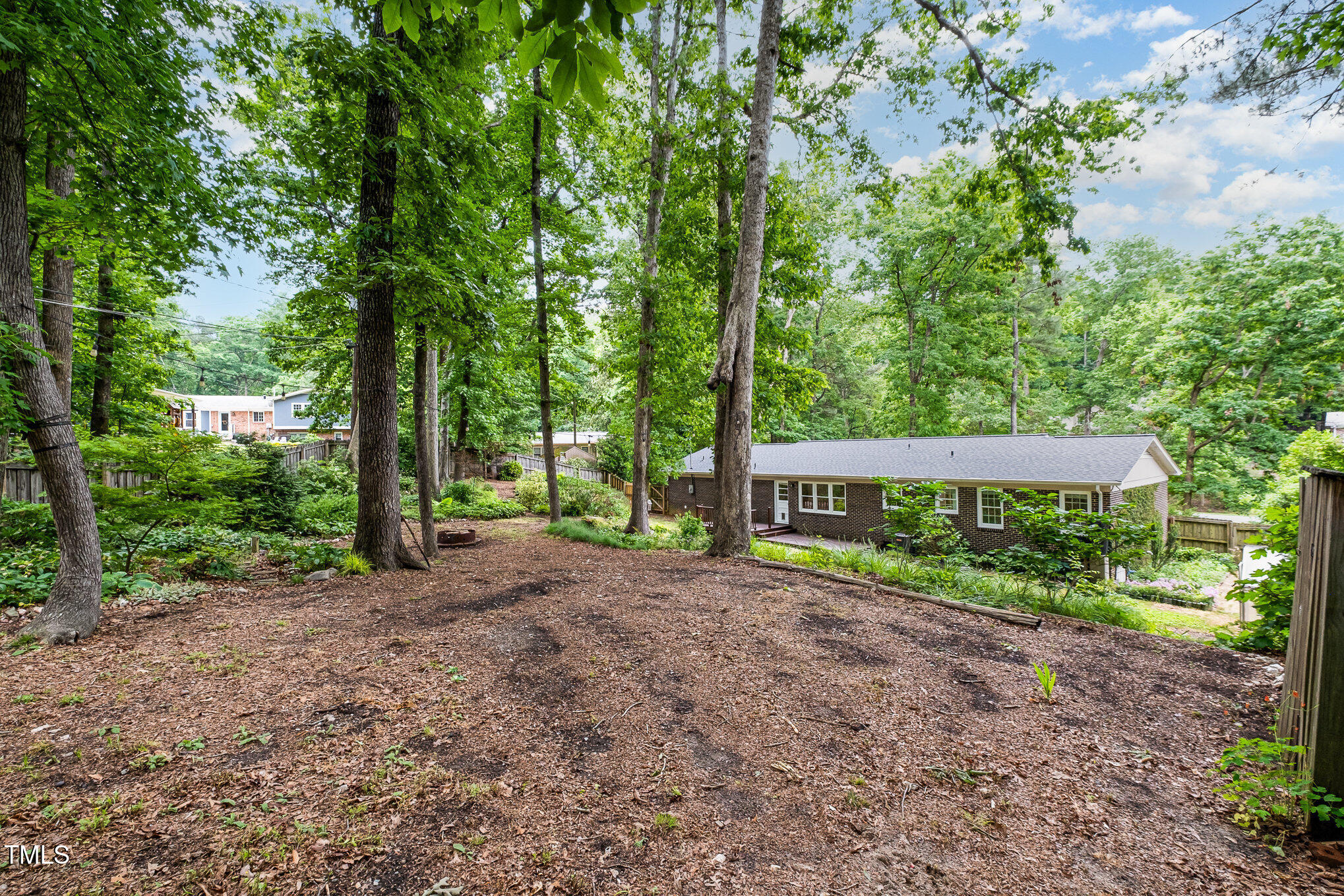 606 Chalice Street Durham, NC 27705 - Photo 25 of 41 a view of a yard with plants and large trees