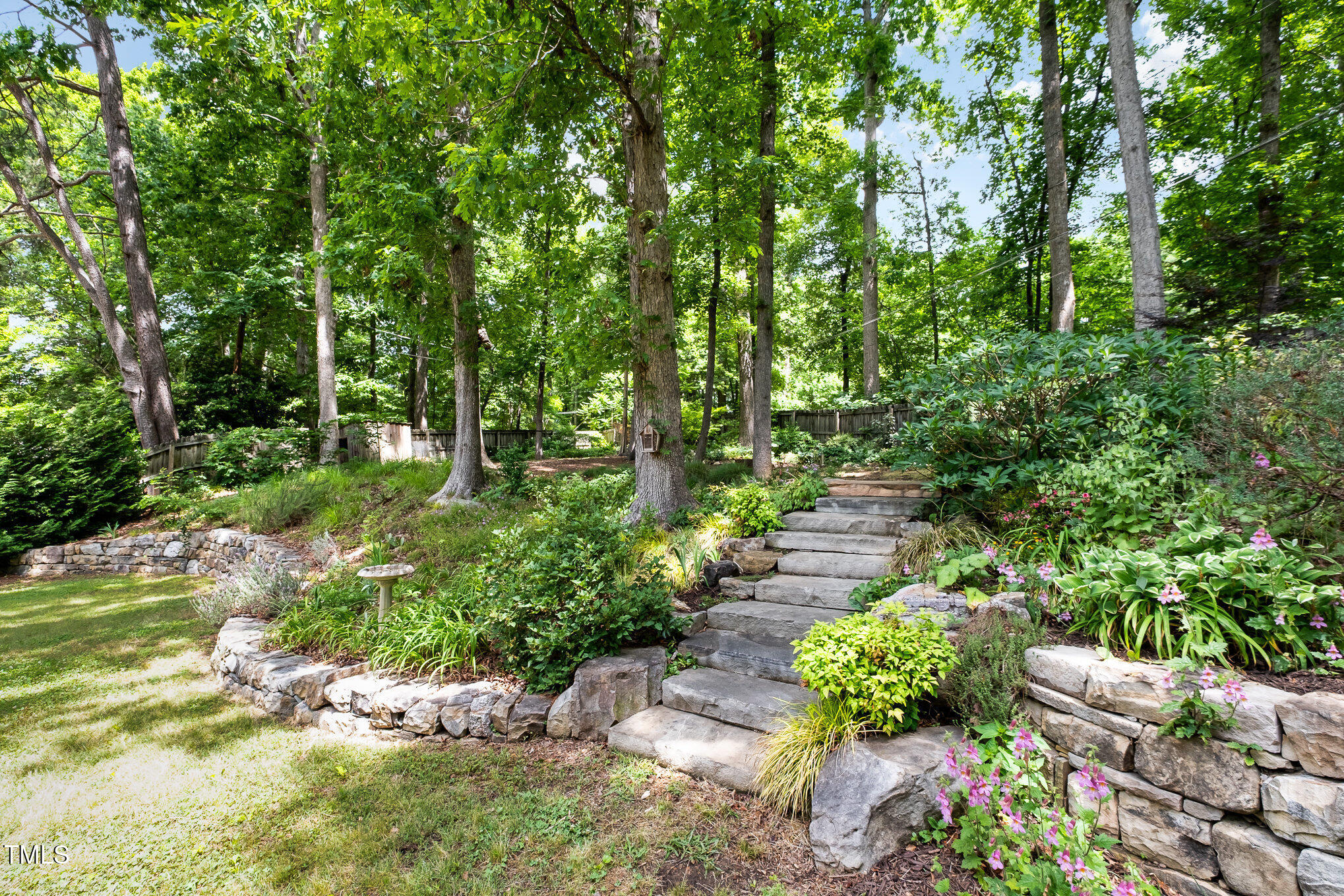606 Chalice Street Durham, NC 27705 - Photo 27 of 41 a view of a garden with plants and large trees