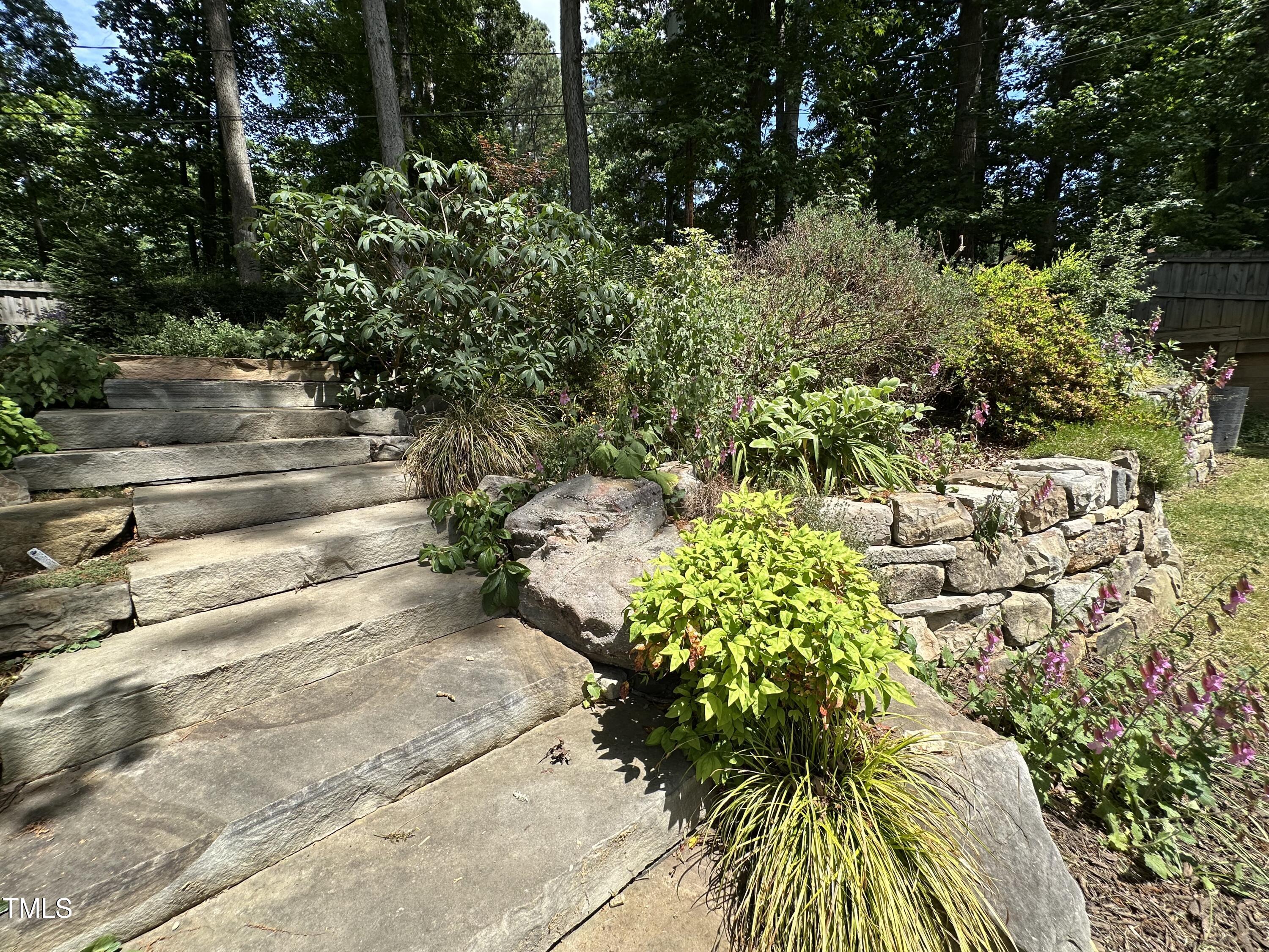 606 Chalice Street Durham, NC 27705 - Photo 31 of 41 a backyard of a house with lots of green space and garden