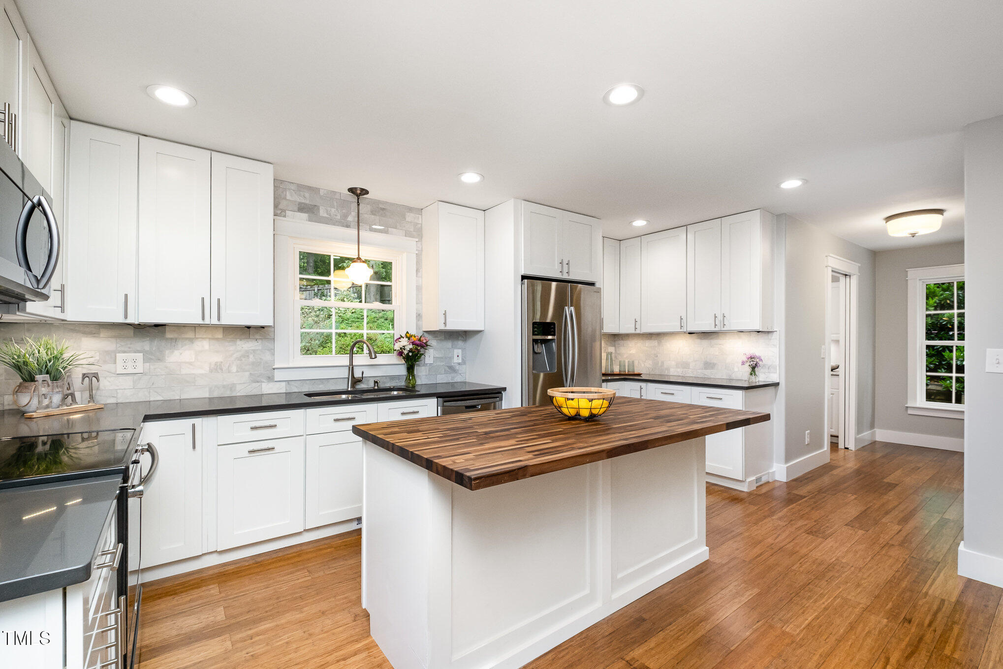606 Chalice Street Durham, NC 27705 - Photo 9 of 41 a kitchen with stainless steel appliances granite countertop a sink stove and refrigerator