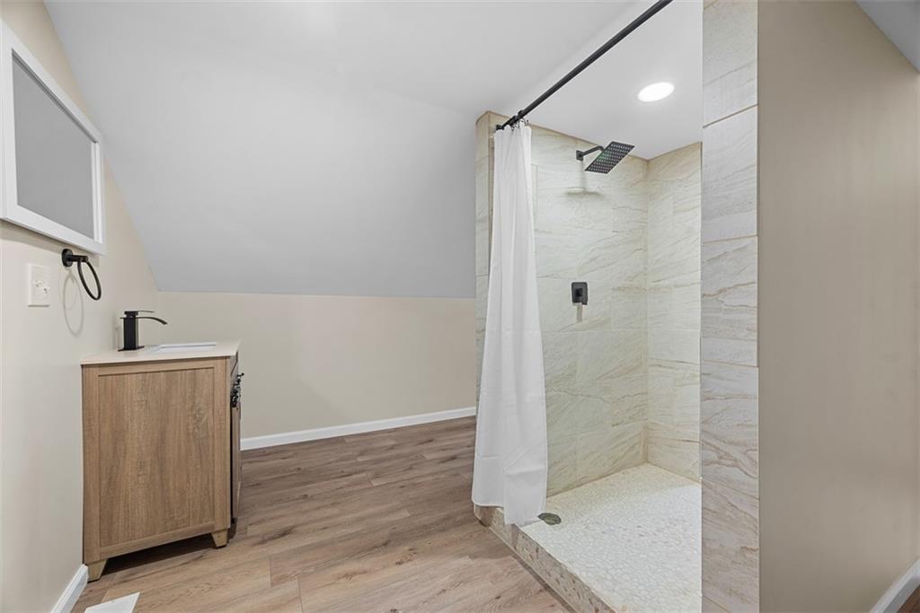 4617 Mt Troy Rd Extension Pittsburgh, PA 15214 - Photo 12 of 19 a bathroom with a shower and a sink