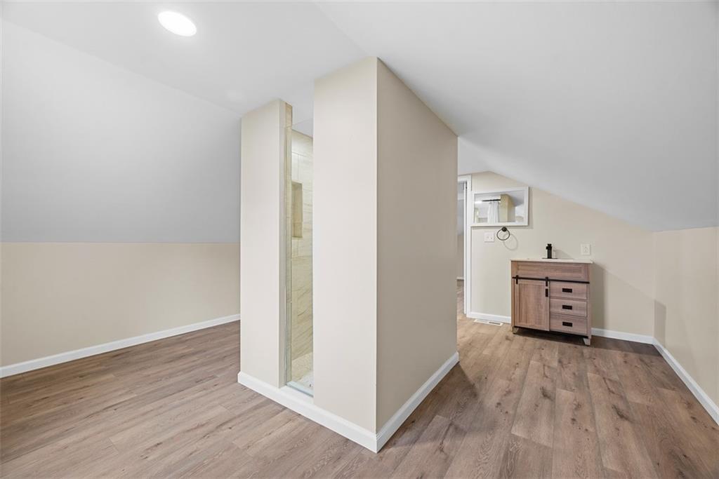 4617 Mt Troy Rd Extension Pittsburgh, PA 15214 - Photo 13 of 19 an empty room with wooden floor and windows