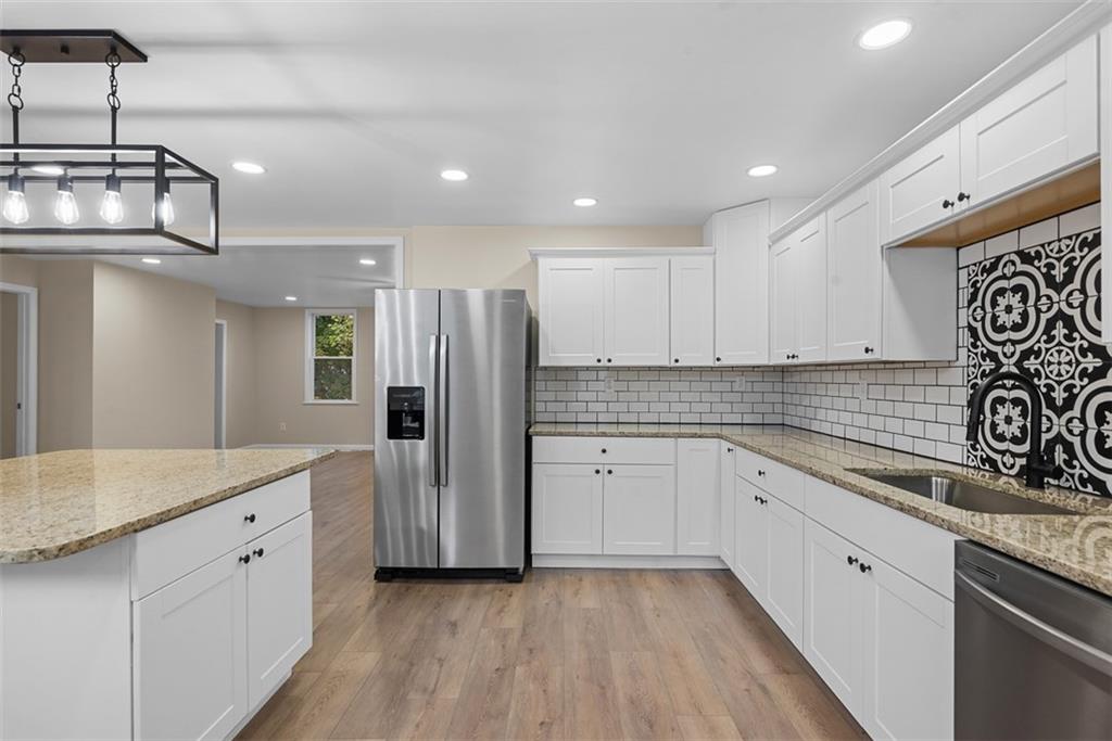 4617 Mt Troy Rd Extension Pittsburgh, PA 15214 - Photo 5 of 19 a kitchen with white cabinets and stainless steel appliances