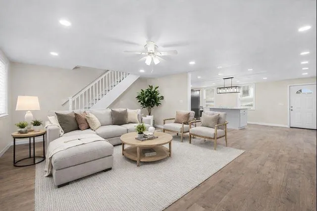 a living room with furniture and a chandelier