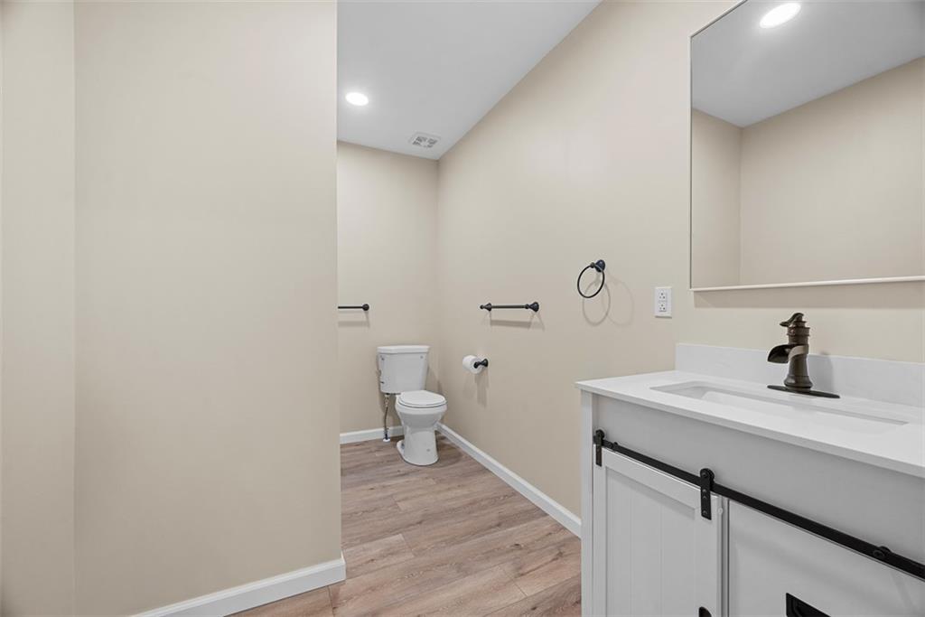 4617 Mt Troy Rd Extension Pittsburgh, PA 15214 - Photo 8 of 19 a bathroom with a sink a toilet and a mirror