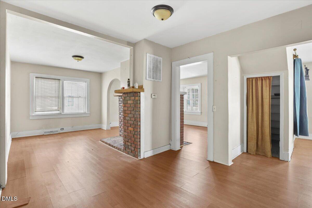 2213 Hunter Hill Road Rocky Mount, NC 27804 - Photo 6 of 11 an empty room with wooden floor and windows