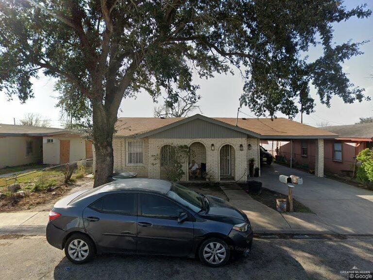 1107 North 19th Street McAllen, TX 78501 - Photo 1 of 1 View of front of property featuring brick siding, a carport, and concrete driveway