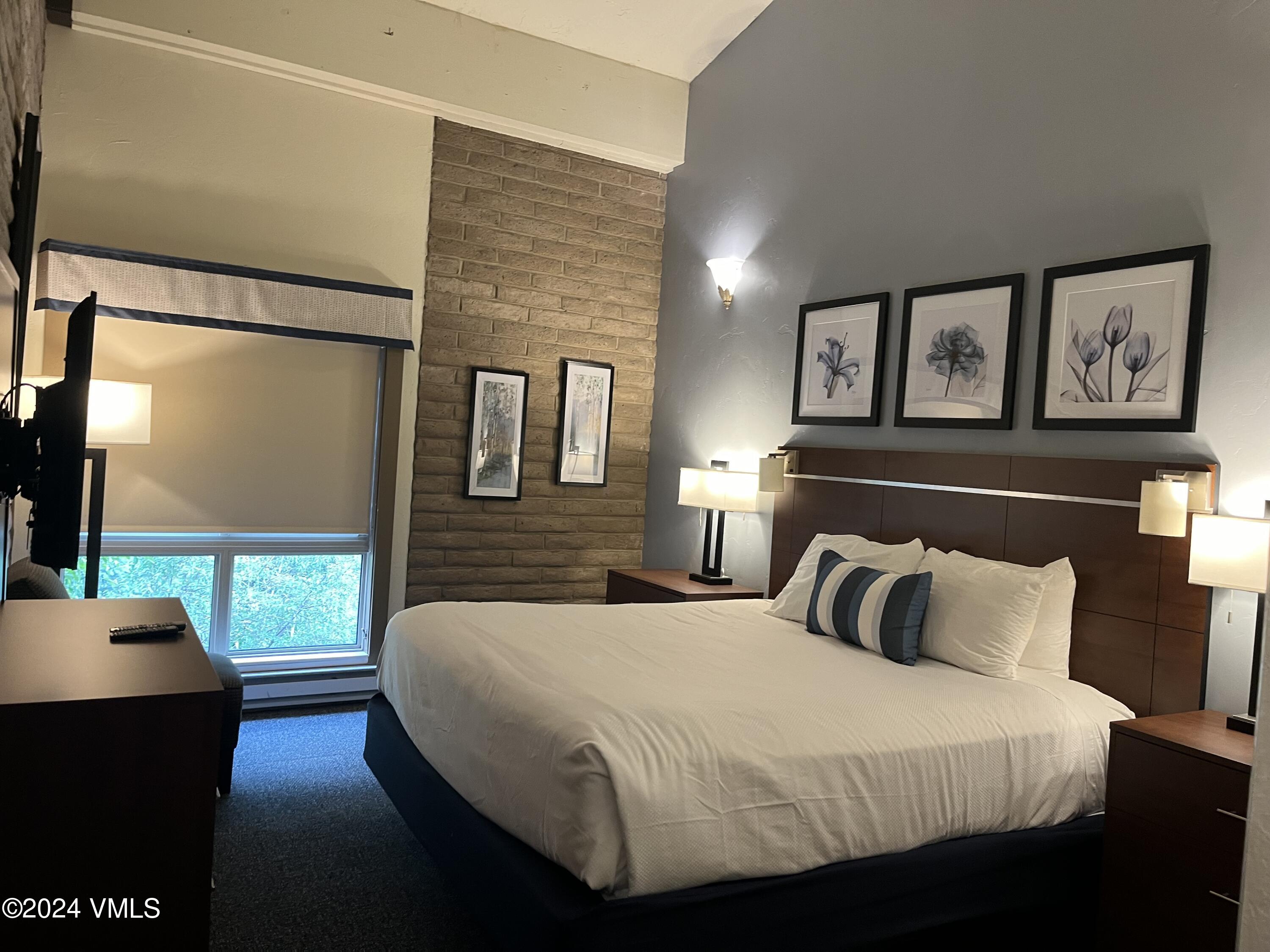 1020 Vail View Drive, Unit 331241 Vail, CO 81657 - Photo 4 of 19 a bedroom with a bed and wooden floor