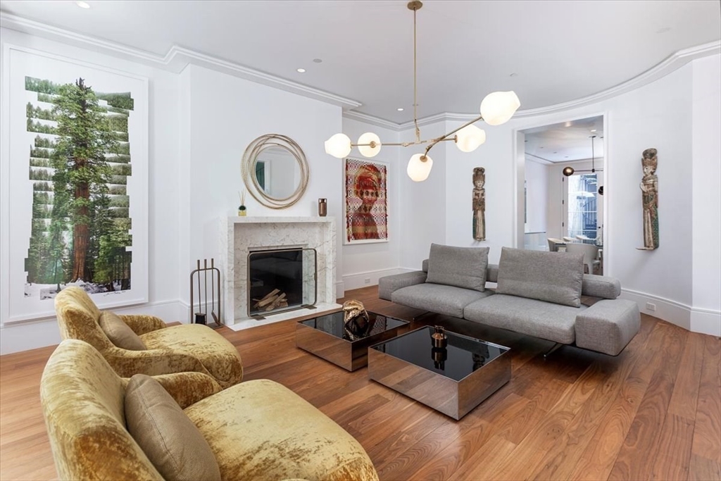 21 Chestnut Street Boston, MA 02108 - Photo 2 of 24 a living room with furniture a fireplace and a chandelier