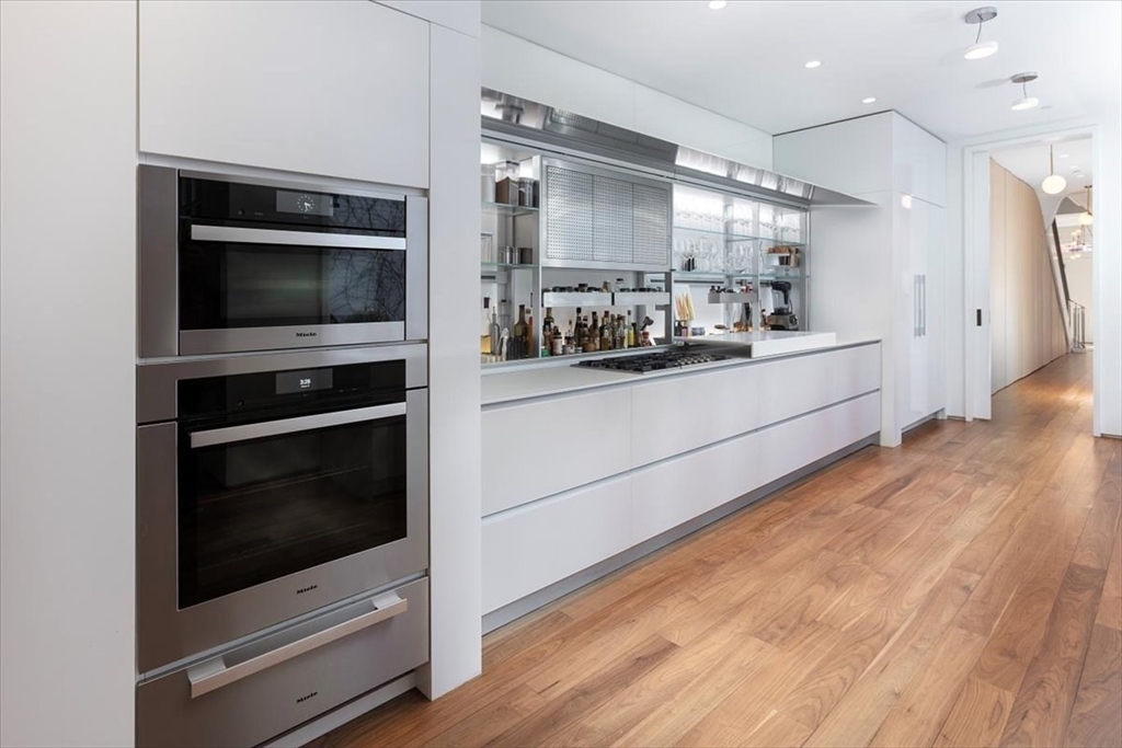 21 Chestnut Street Boston, MA 02108 - Photo 7 of 24 a kitchen with stainless steel appliances kitchen island granite countertop a stove a microwave and a hard wood floors