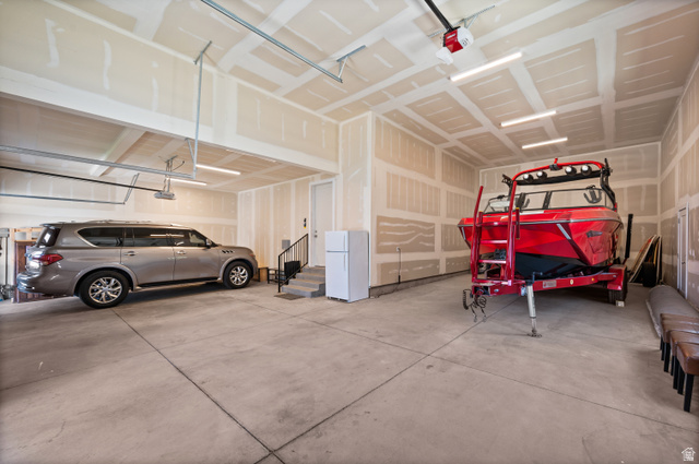 507 West Windmill Gate Cove Draper, UT 84020 - Photo 43 of 46 Garage featuring freestanding refrigerator and a garage door opener