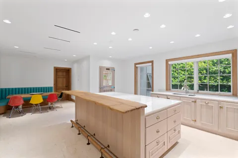 a kitchen that has a stove and a wooden floor