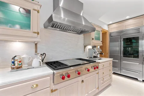 a kitchen with stainless steel appliances cabinets and stove