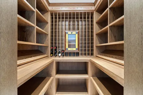 a view of a patio with table and chairs potted plants with floor to ceiling window