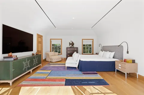 a bathroom with a bathtub a sink a vanity a window and a shower