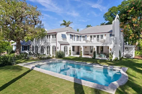 a view of a house with swimming pool and sitting area