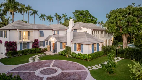 a front view of a house with a yard table and chairs