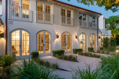 a view of swimming pool with a garden and plants
