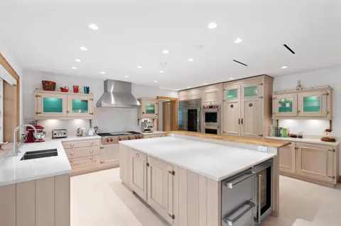 a kitchen with stainless steel appliances a sink stove and cabinets