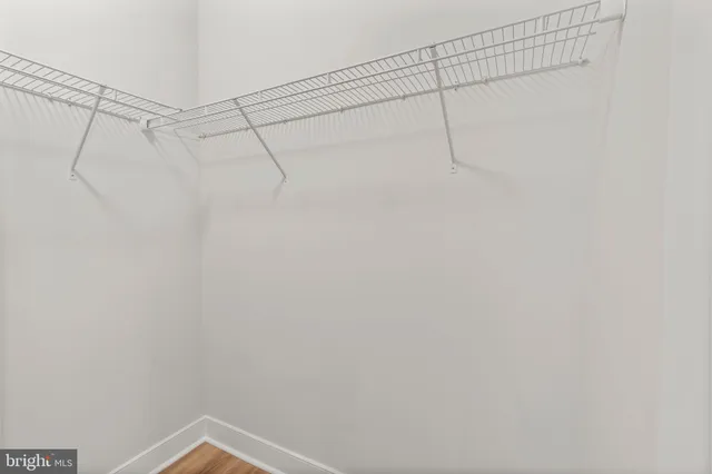 a view of a swimming pool with a table and chairs under an umbrella
