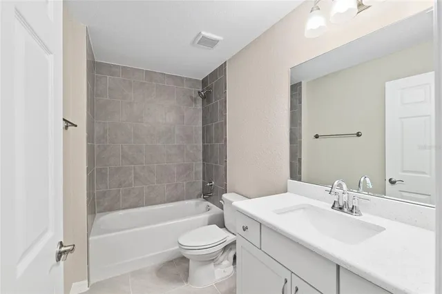 a bathroom with a toilet a sink and bathtub