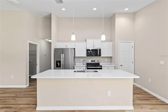 a kitchen with stainless steel appliances a refrigerator sink and stove