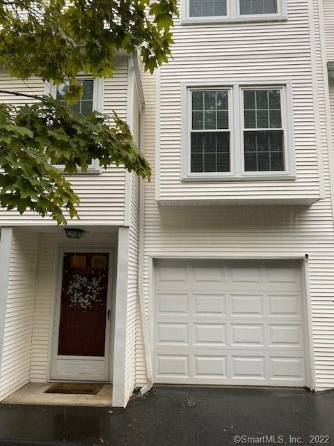 380 Hitchcock Road, Unit 276 Waterbury, CT 06705 - Photo 1 of 1 a front view of a house with a garage