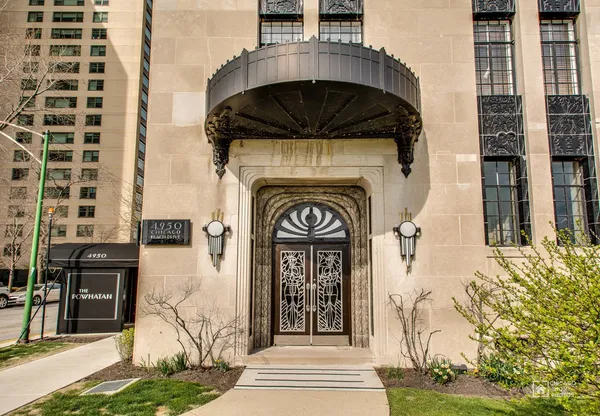 a view of entrance gate of a building with a garden