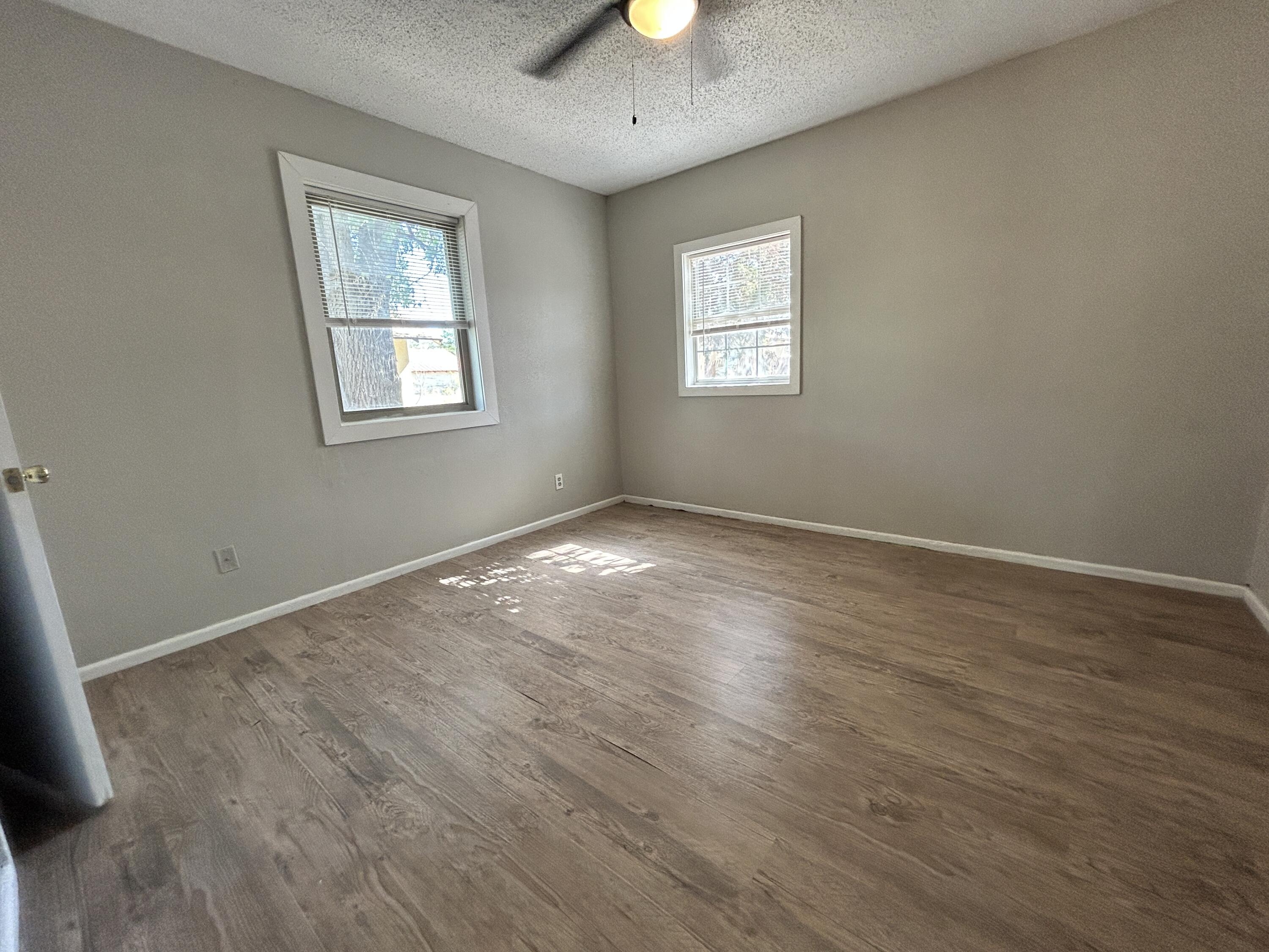 1313 25th Street Lubbock, TX 79411 - Photo 9 of 9 a view of an empty room with window and wooden floor