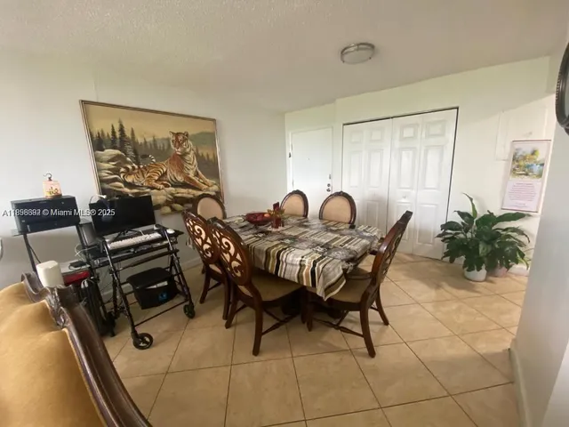 a dining room with furniture and potted plants