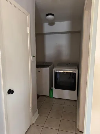 a hallway with washer and dryer