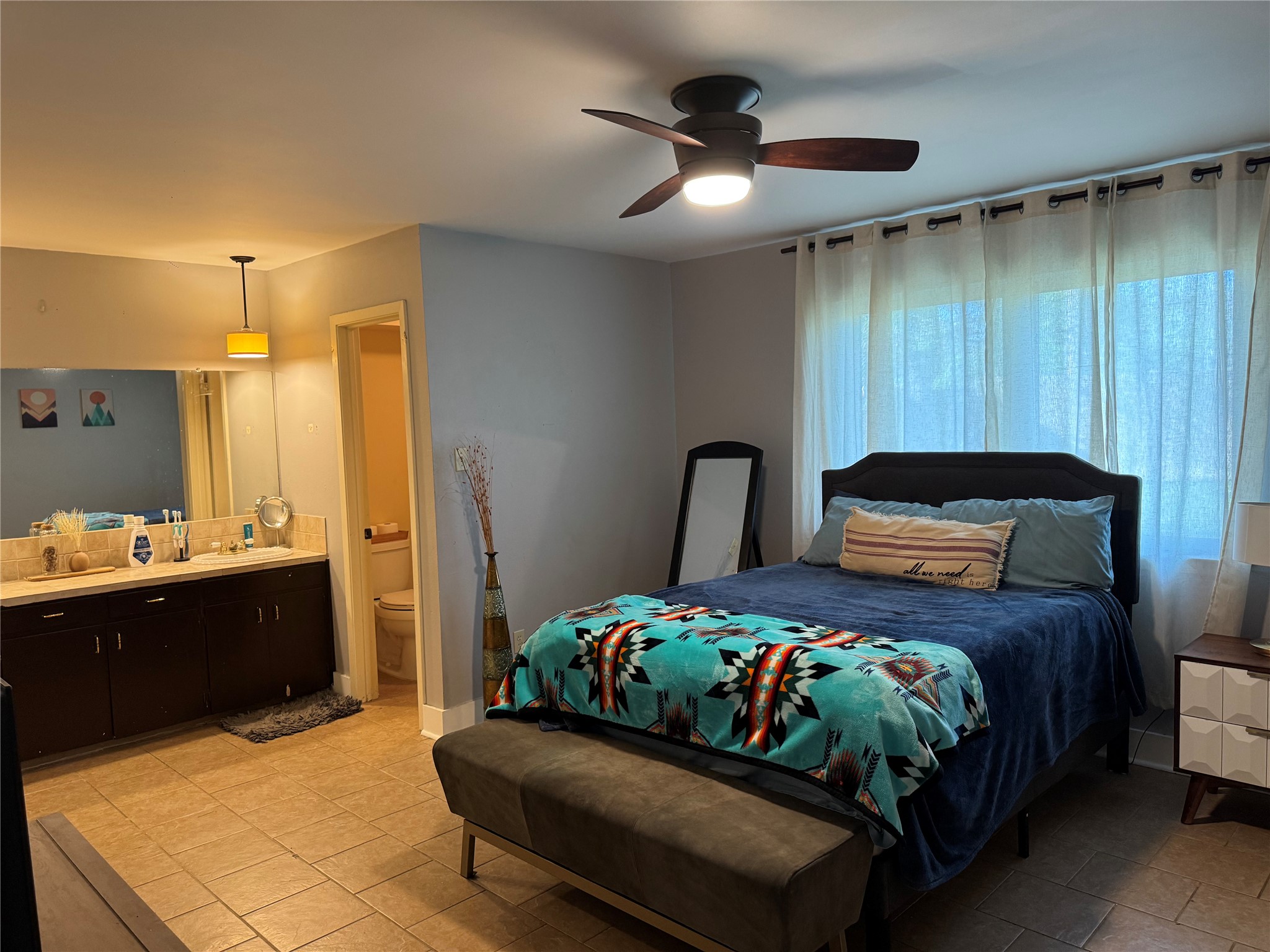 102 Skyloop Drive Austin, TX 78745 - Photo 8 of 18 a bedroom with a bed and a chandelier