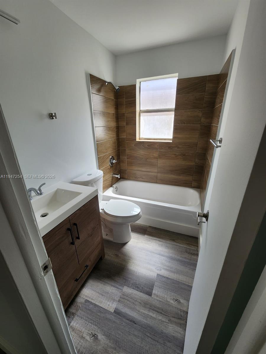 4545 Treehouse Lane, Unit H Tamarac, FL 33319 - Photo 16 of 18 a bathroom with a sink toilet and shower