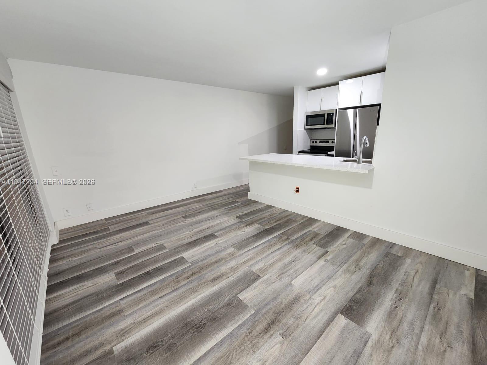 4545 Treehouse Lane, Unit H Tamarac, FL 33319 - Photo 4 of 18 a view of room with window