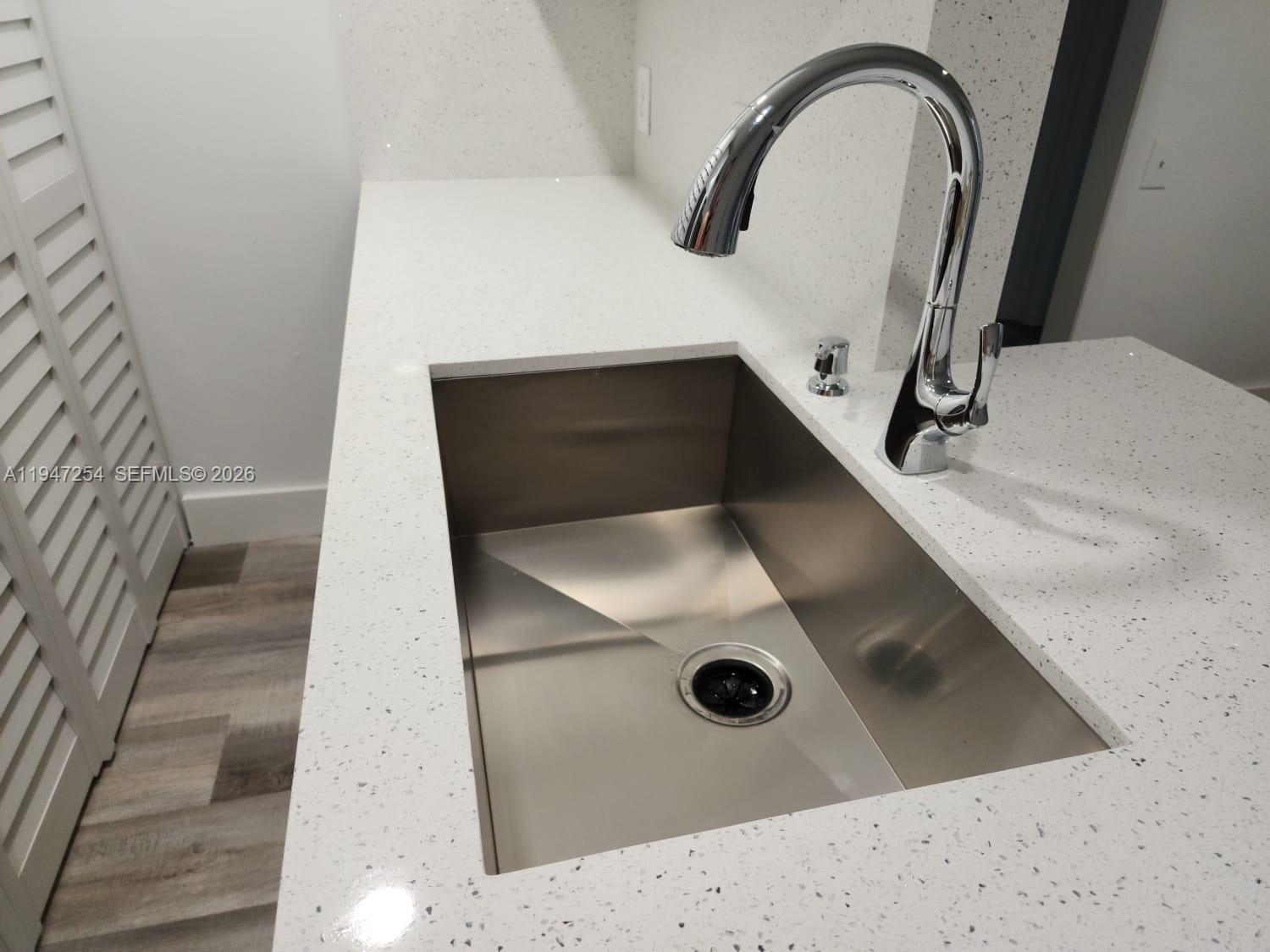 4545 Treehouse Lane, Unit H Tamarac, FL 33319 - Photo 5 of 18 a bathroom with a sink and mirror