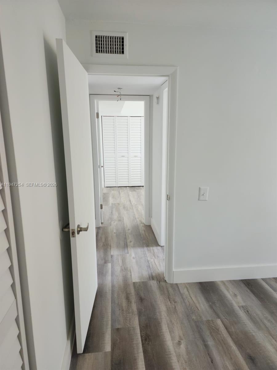 4545 Treehouse Lane, Unit H Tamarac, FL 33319 - Photo 8 of 18 wooden floor in a gallery