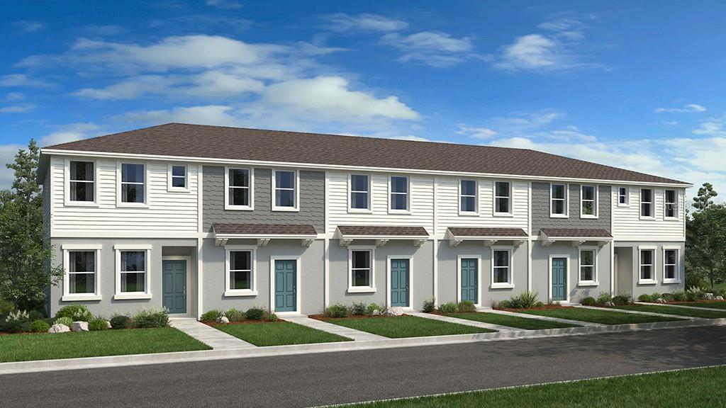 a front view of a residential apartment building with a yard