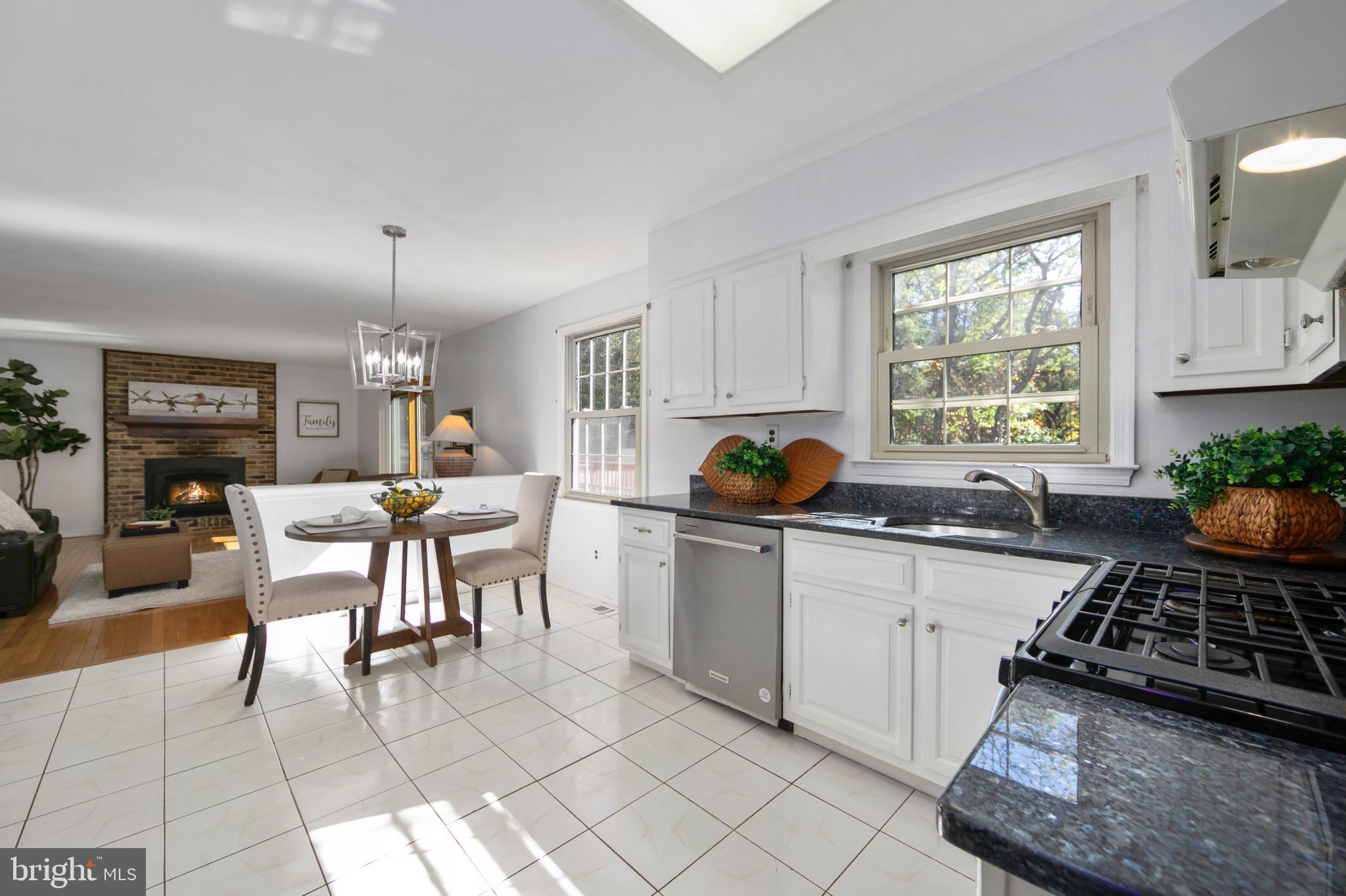 219 Dock Road Marlton, NJ 08053 - Photo 11 of 51 a kitchen with stainless steel appliances a table and chairs in it