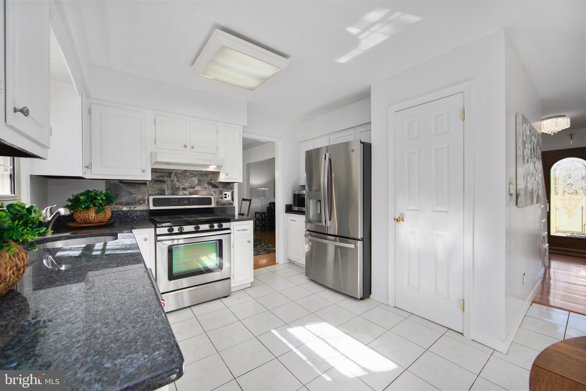 219 Dock Road Marlton, NJ 08053 - Photo 12 of 51 a kitchen with a refrigerator a microwave a sink and a stove