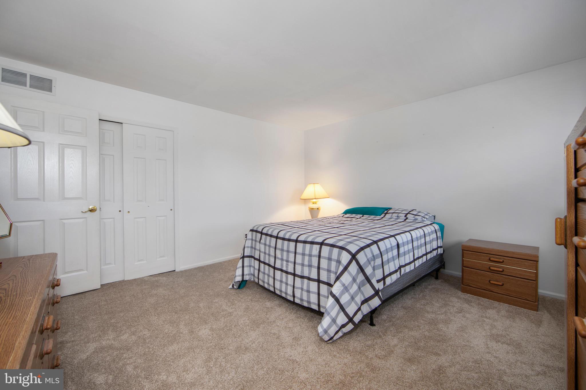 219 Dock Road Marlton, NJ 08053 - Photo 35 of 51 a bedroom with a bed and a lamp with the table chair