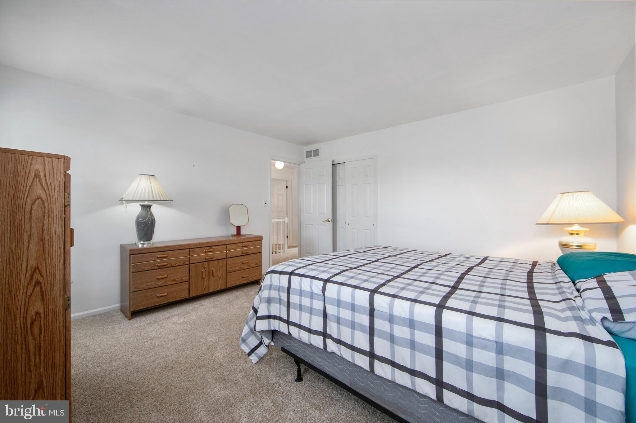 219 Dock Road Marlton, NJ 08053 - Photo 36 of 51 a bedroom with a bed and a lamp